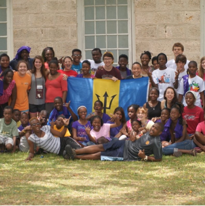 Campers and counselors holding the flag of Barbados