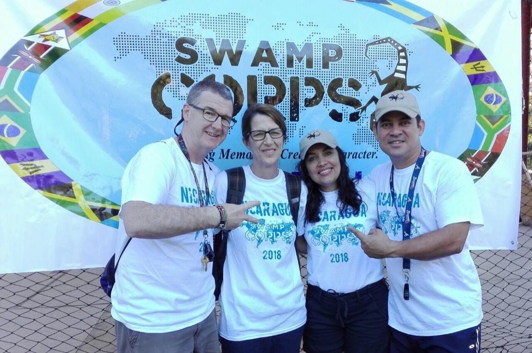 Four Swamp Corps leaders in front of a Swamp Corps banner in Nicaragua, 2018
