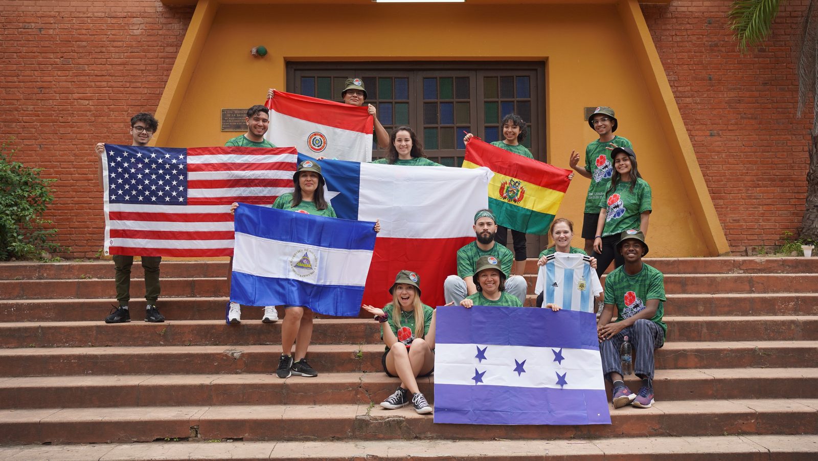 Campers holding the flags of seven countries