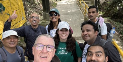 A Swamp Corps team taking a group selfie on a trail