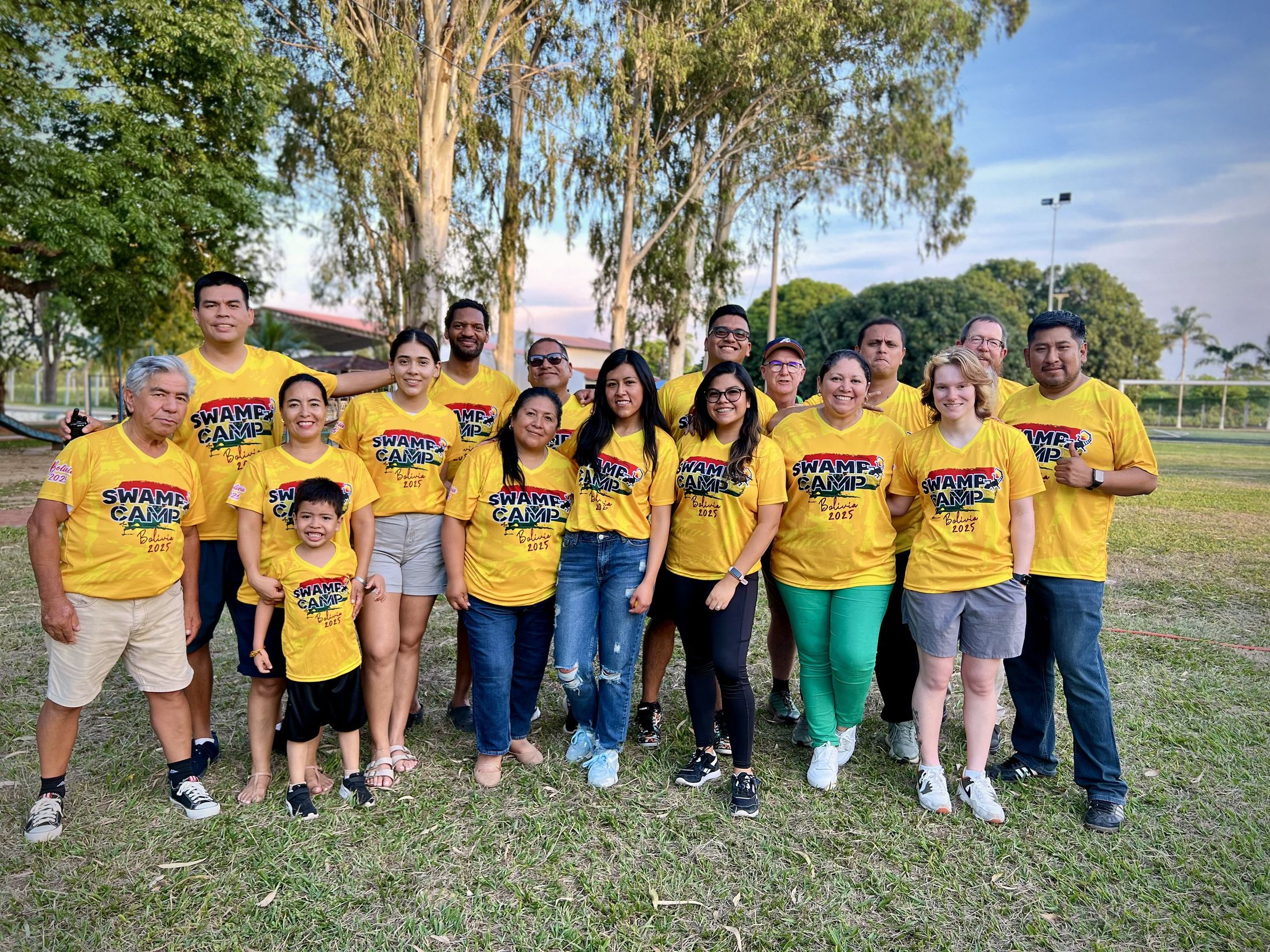The Swamp Corps team in yellow Swamp Camp shirts on the lawn