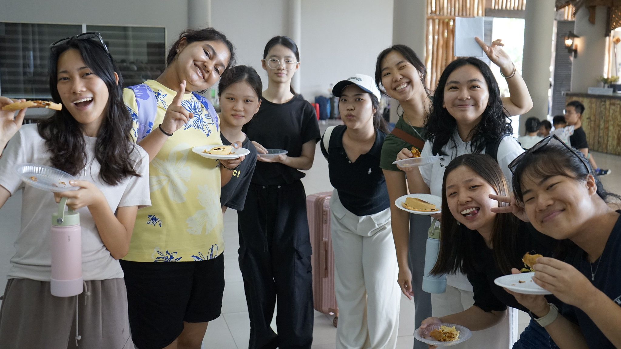 Young women at Swamp Camp Malaysia smiling over plates of food