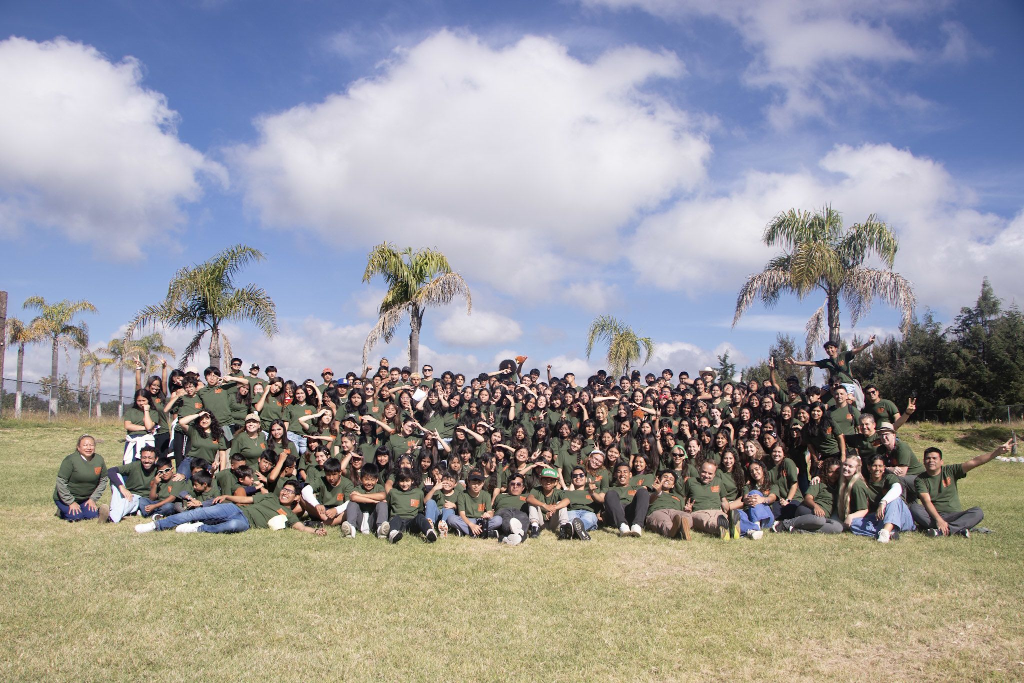 The whole of Swamp Camp Mexico 2026 gathered on the lawn under a big sky
