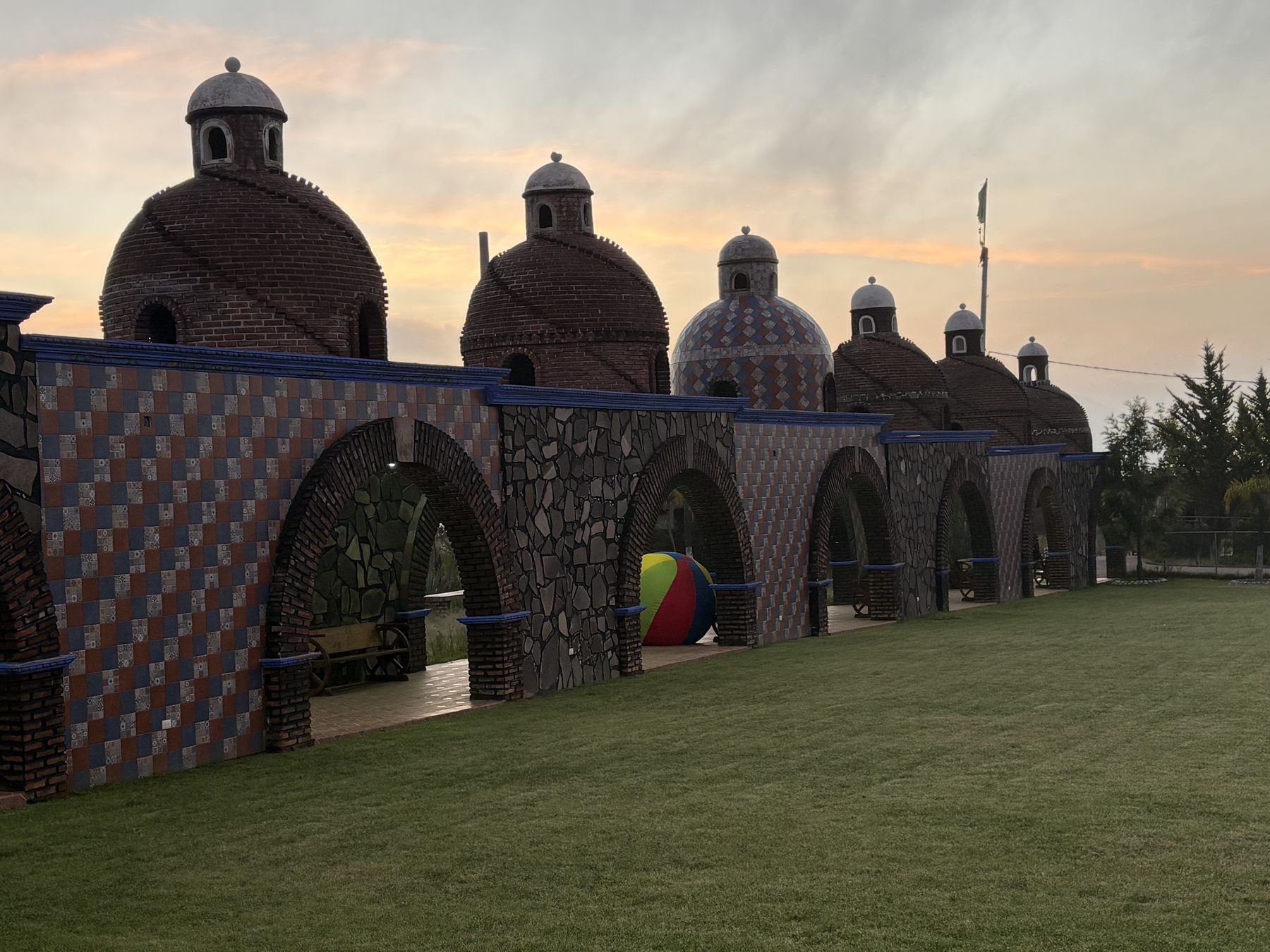 Brick and tile domes over stone arches at dusk at the camp in Mexico
