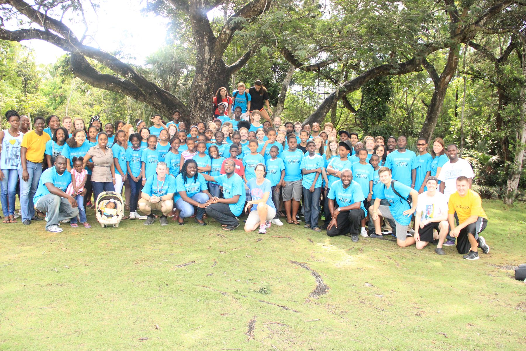 The first Bahamas camp in blue shirts under a spreading tree