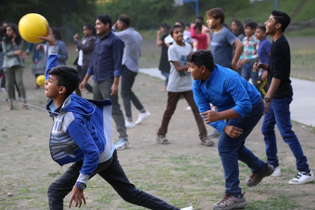 Campers mid-game as a yellow dodgeball flies